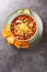 Hearty chicken taco soup packed with black beans, corn, and tomatoes with green chile peppers close-up in a plate. Vertical top