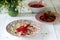 A hearty homemade breakfast or lunch - dumpling or vareniki with strawberries and strawberry sauce. Rustic style.