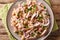 Hearty homemade salad with tuna, onions and white beans close-up in a plate. horizontal top view