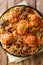 Hearty Italian lunch of spaghetti served with meatballs, cheese and mushroom closeup in a plate. Vertical top view