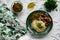 A hearty meal on the table, spaghetti with fried pork chunks, green canned peas and watercress grass. Next to the sauce