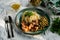 A hearty meal on the table, spaghetti with fried pork chunks, green canned peas and watercress grass. Next to the sauce