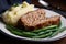 Hearty meatloaf made with ground beef, pork, and veal, served with a side of buttery garlic green beans