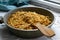 Hearty pasta noodles with fried vegetables, onions and carrots in a frying pan.  Delicious homemade food for the whole family