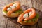 Hearty sandwiches with salmon, mozzarella, lettuce, onion and ra