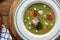 Hearty traditional Dutch pea soup with smoked sausage, rye bread and bacon. Or: `erwtensoep met rookworst, roggebrood en