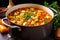 hearty vegetable soup simmering in a metal pot