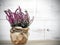 Heather bouquet on white wooden background