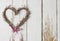 Heather erica door wreath in heart shape on wooden background