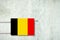 Heating battery, in the colors of the Belgium flag on a concrete wall. Copy space. Raising heating prices. Heat saving