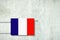 Heating battery, in the colors of the France flag on a concrete wall. Copy space. Raising heating prices. Heat saving