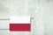 Heating battery, in the colors of the Poland flag on a concrete wall. Copy space. Raising heating prices. Heat saving