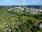 Heating plant with high chimney in city, close to the allotment gardens, aerial view