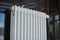 Heating radiator in office, close up. White heat exchangers. Iron aluminium steam radiator. Pipe pattern