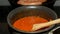 Heating tomato sauce and frying sausages