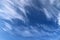 Heavenly background with cirrus clouds against the blue sky on sunny day