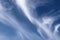 Heavenly background with cirrus clouds against the blue sky on sunny day