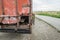 Heavily damaged red container on a trailer