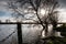 Heavily flooded fields by a riverbank, seen after severe storms within the UK.