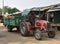 Heavily loaded tractor passing the market stalls