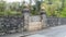 Heavy barred castle gate to a Welsh castle in a high stone wall gate.