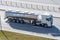 Heavy big fuel tanker with shiny metal lame tank driving on city highway, side aerial view