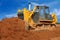 Heavy bulldozer moving sand in sandpit