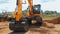 Heavy caterpillar excavator excavation on construction site. Orange excavator