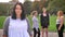 Heavy caucasian beautiful girl smiling in focus with diverse women behind her on the street