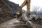 Heavy chain and wheeled equipment clears the highway after a rock collapse