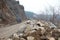 Heavy chain and wheeled equipment clears the highway after a rock collapse