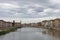 Heavy clouds over Arno River and waterfront buildings, Pisa