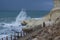 Heavy clouds with stormy waves beating against rocks and cliffs