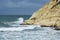 Heavy clouds with stormy waves beating against rocks and cliffs