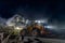 Heavy construction and mining machinery unloading gravel into silos on the night shift