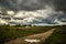 Heavy dramatic rain sky in countryside landscape