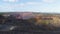 Heavy dump truck carrying the iron ore on the opencast mining aerial view