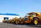 Heavy-duty trucks warehouse at autoworks. Giant mining dump trucks manufacture by the heavy vehicle plant.