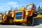 Heavy-duty trucks warehouse at autoworks. Giant mining dump trucks manufacture by the heavy vehicle plant.