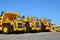 Heavy-duty trucks warehouse at autoworks. Giant mining dump trucks manufacture by the heavy vehicle plant.