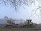 Heavy Earth Moving Equipment in an Open Field on a Foggy Morning