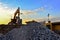 Heavy excavator bucket working in quarry on a background of sunset and blue sky