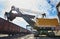 Heavy excavator loading gravel into train for rail freightage