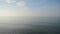 Heavy fog floating over blue fjord surface and blue sky timelapse