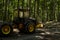 Heavy forest machine in the forest during logging. Yellow-black forest tractor with chains at work. Trimmed trees in the