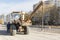 Heavy front loader for transportation of bulky goods. Road repair in the center of a modern city in autumn. Heavy construction