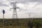 Heavy grey clouds in the cold autumn sky over green fields, trees, forests, streams. Before storm. Electric poles