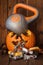 Heavy kettlebell crushing carved Halloween pumpkin.