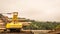 Heavy machinery loading timber into the barge