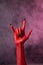 Heavy metal, red devil hand with black nails